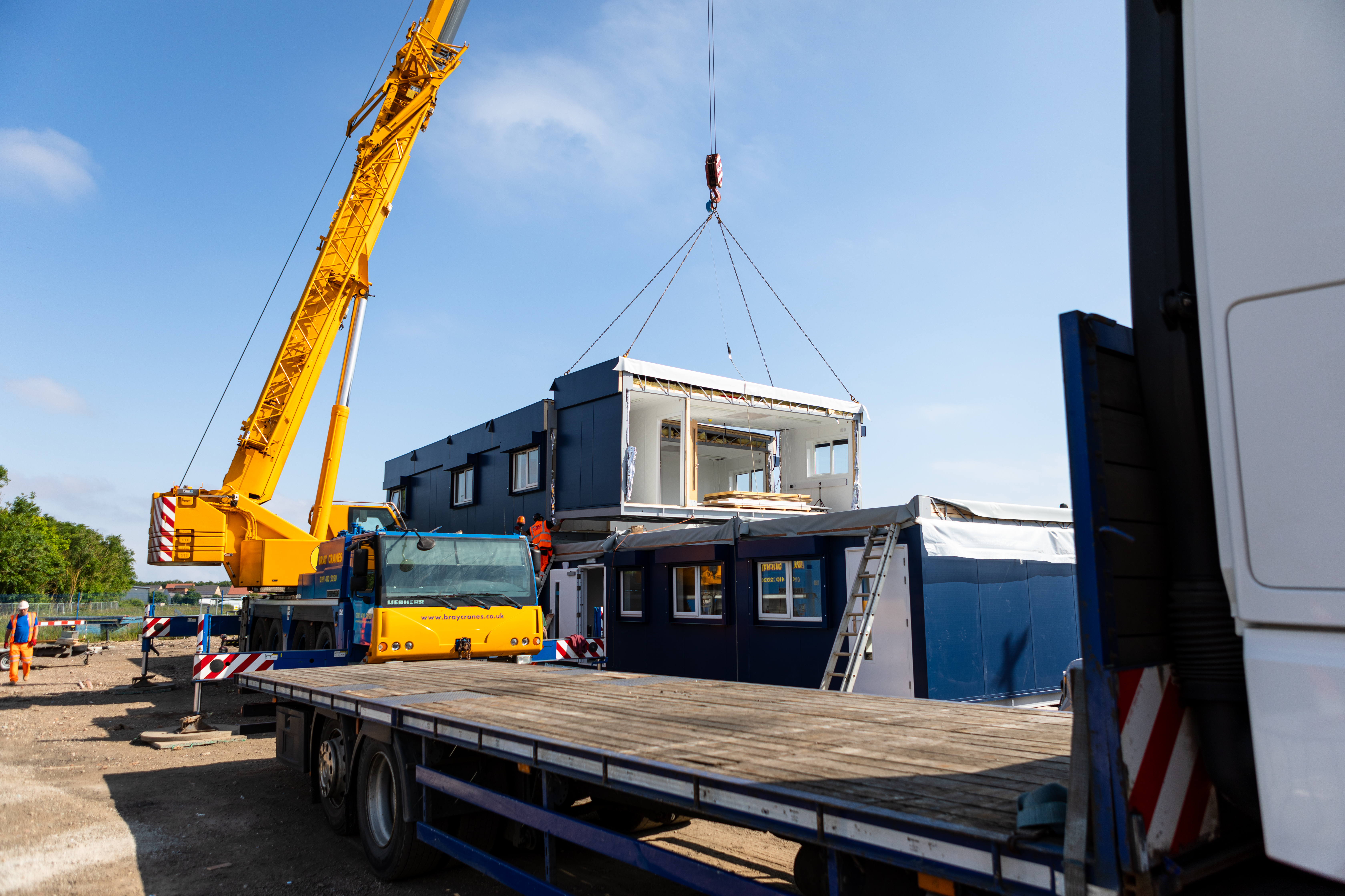 a modular being being assembled into a multi storey projects via crane