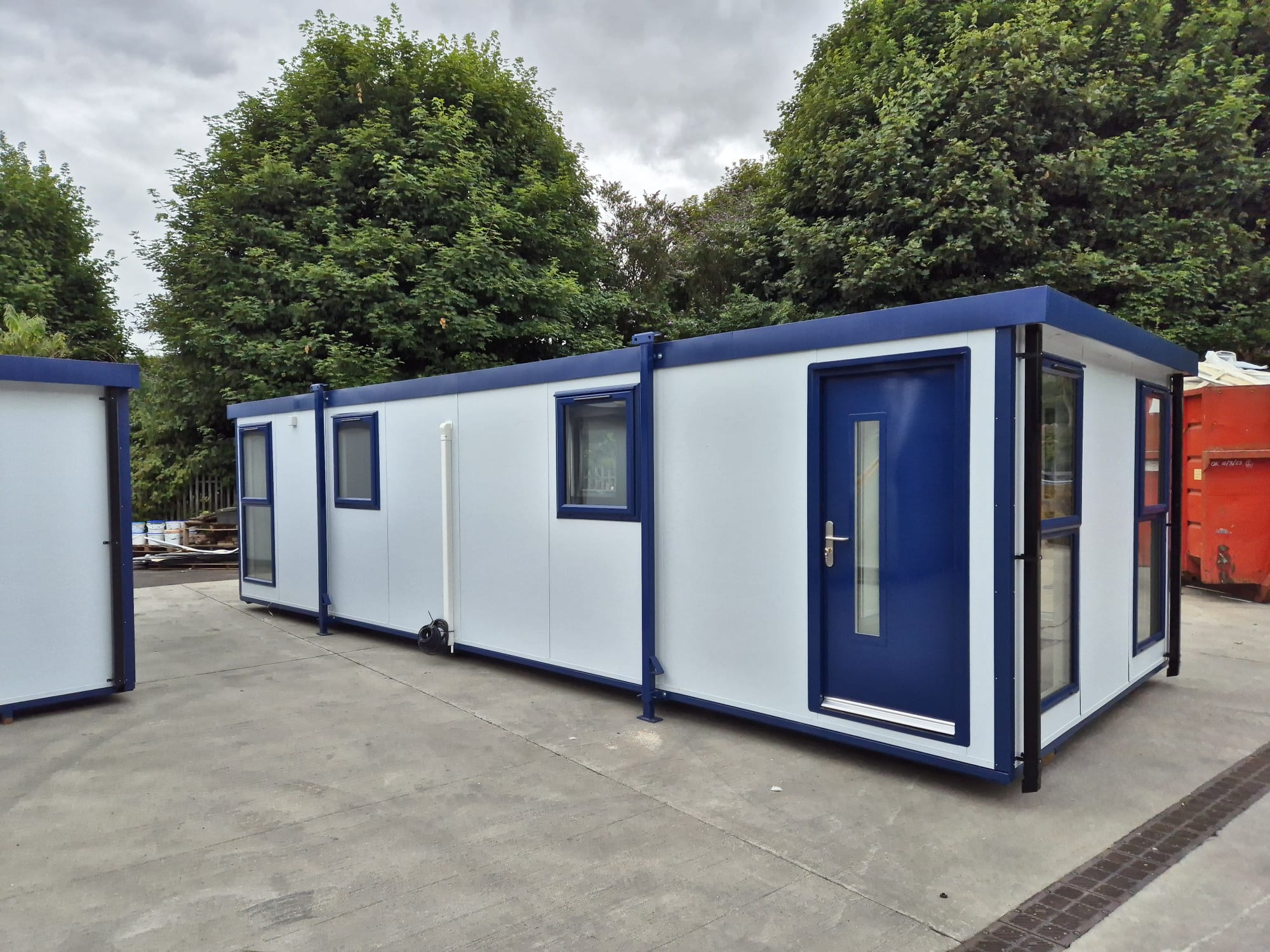 a white modular cabin with blue finishes